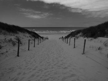 Scenic view of beach against sky during winter
