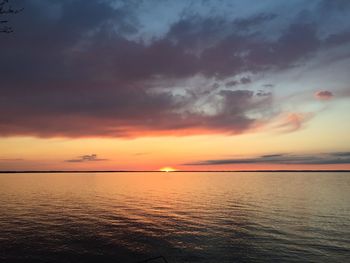 Scenic view of sea against dramatic sky during sunset