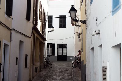 Bicycle parked by houses in city