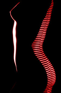 Close-up of silhouette person standing against black background