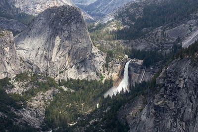 Scenic view of waterfall against mountains