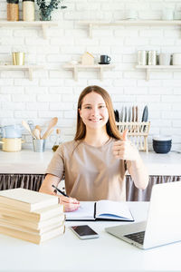 Portrait of smiling young woman using smart phone