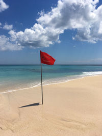 Lifeguard hut on beach against sky