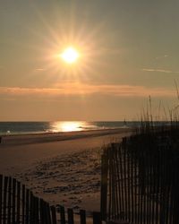 Scenic view of beach against sky during sunset