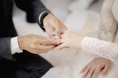 Midsection of business people stacking hands