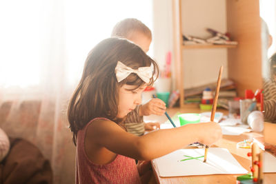 Cute girl painting at home