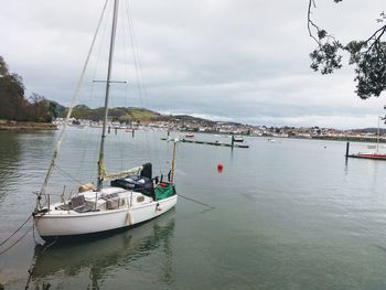 Boats moored on sea against sky