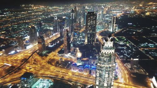 Aerial view of city lit up at night