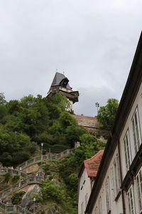 Traditional building by trees against sky