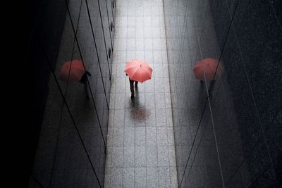 High angle view of person holding red umbrella