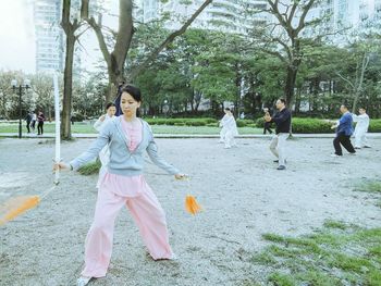 Full length of woman on grass against trees