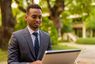 Portrait of young man using mobile phone outdoors