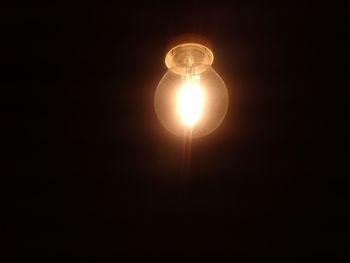 Low angle view of illuminated light bulb