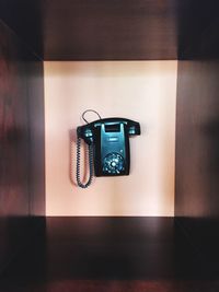 Close-up of telephone booth on wall