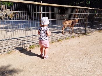 Full length of woman standing on wall