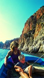 Boattrip with mother and son on rock by sea against sky in alanya / turkey