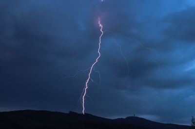 Low angle view of lightning against sky at night