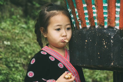 Portrait of cute girl standing outdoors