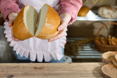 Cropped hand of person holding food on table