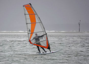 Sailboat on sea against sky