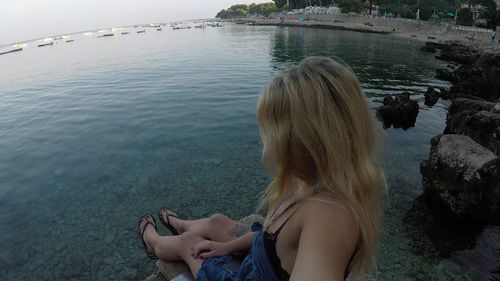 Woman sitting in sea