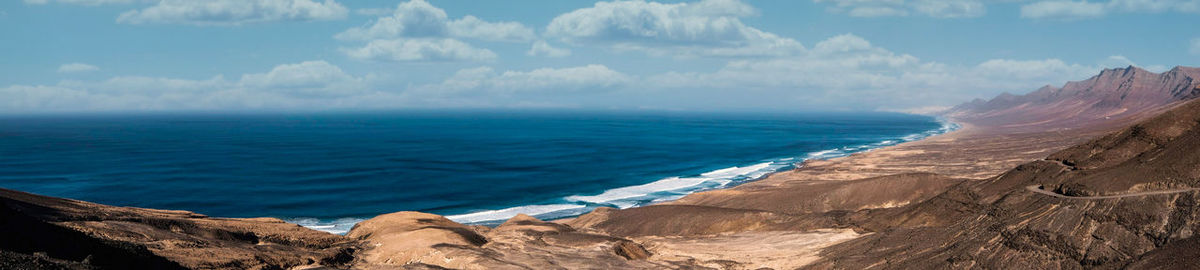 Panoramic view of sea and rocks against sky