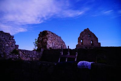 Low angle view of old building against blue sky