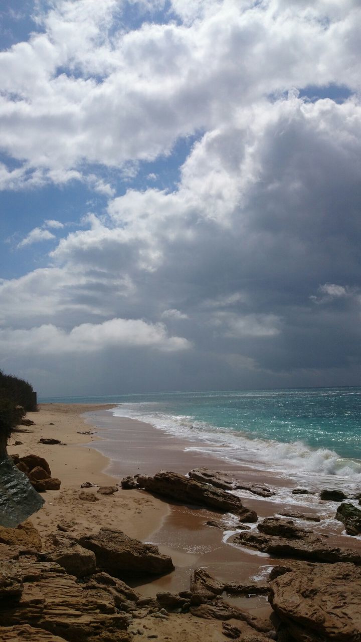 sea, sky, water, horizon over water, tranquil scene, scenics, tranquility, beach, beauty in nature, cloud - sky, shore, nature, cloudy, rock - object, cloud, idyllic, coastline, outdoors, remote, day