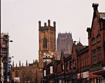 Buildings in city against clear sky