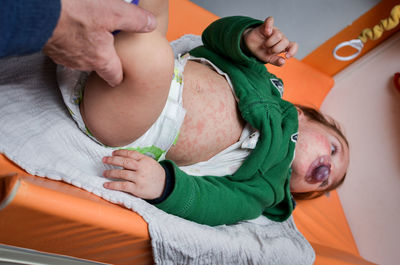 Midsection of baby girl sitting on sofa