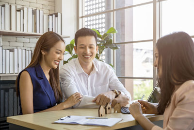 Couple with agent on table