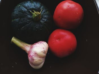 High angle view of strawberries on table against black background