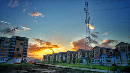 Buildings against cloudy sky at sunset