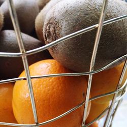 Close-up of orange fruit in container