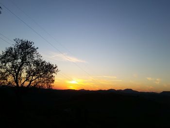 Scenic view of silhouette landscape against clear sky at sunset