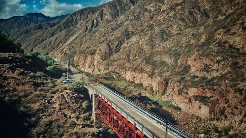 Aerial view of bridge by mountain range