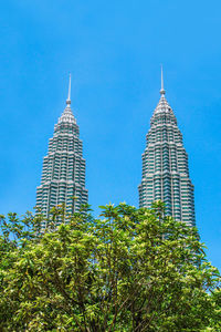 Kuala lumpur, malaysia, february 21, 2020. petronas twin towers against blue sky.