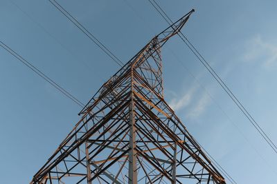 Low angle view of electricity pylon against sky