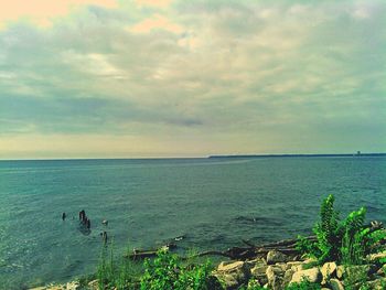 Scenic view of sea against cloudy sky