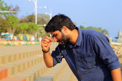 Young man washing face with water