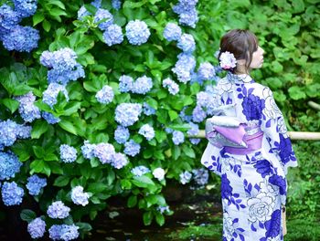 Woman standing on purple flowering plants