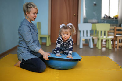 Side view of woman sitting on table