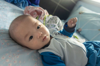 Cute boy lying on bed