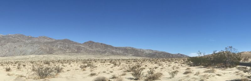 Scenic view of mountains against clear blue sky