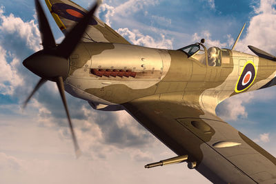 Low angle view of airplane flying against sky