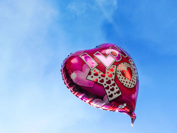 Low angle view of balloon against blue sky