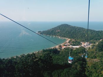 High angle view of overhead cable car over sea against sky