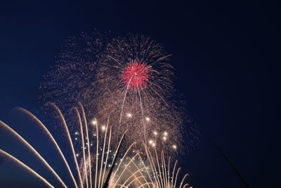 Low angle view of firework display at night