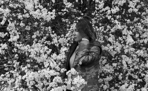 Low section of woman standing on field