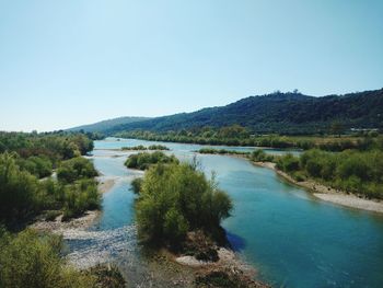 Scenic view of lake against clear blue sky